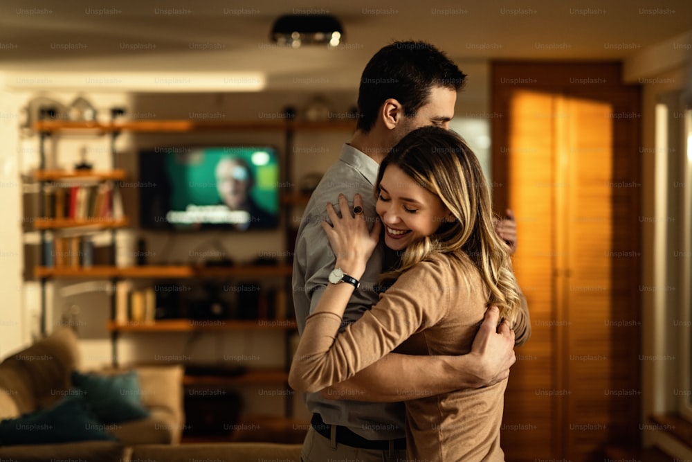 Young couple in love dancing in the living room.