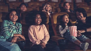 People audience watching movie in the movie theater cinema. Group recreation activity and entertainment concept.