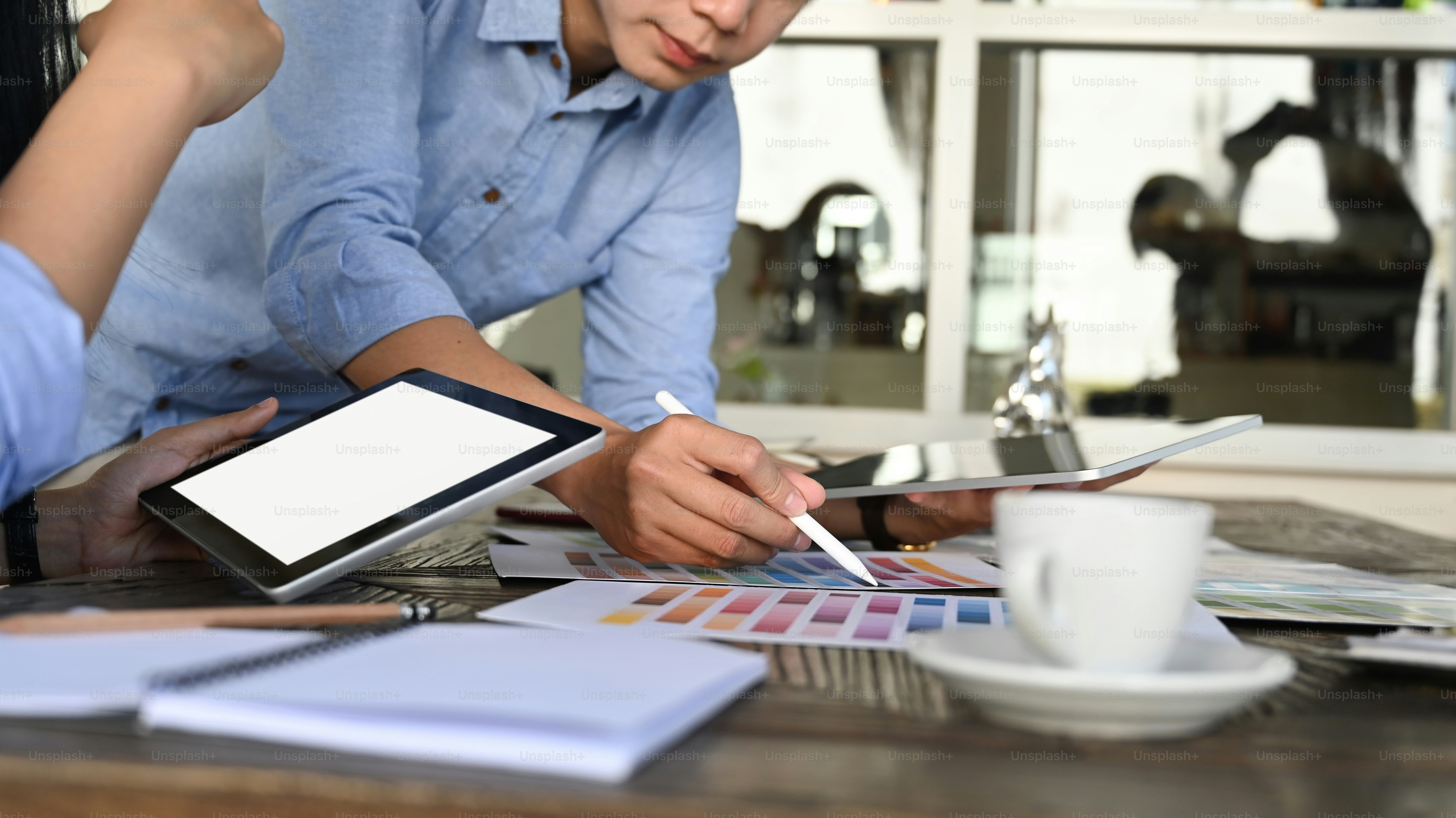 Cropped image of business development team discussing/talking/meeting ...