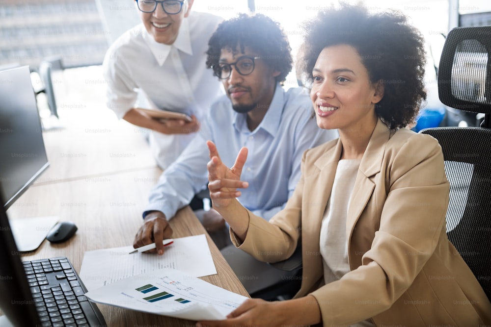 Group of successful happy business people at work in office