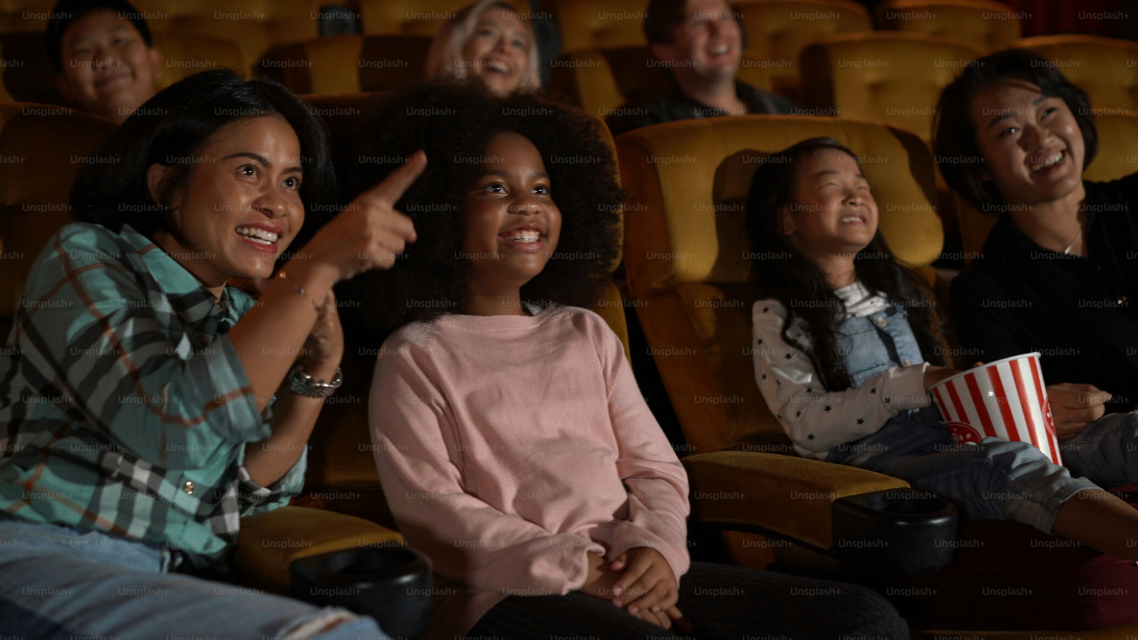 People audience watching movie in the movie theater cinema. Group recreation activity and entertainment concept.