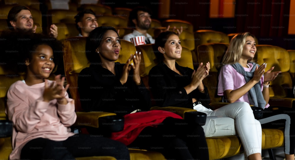 Group of audience happy and fun watch cinema in movie theater. Group recreation activity and entertainment concept.