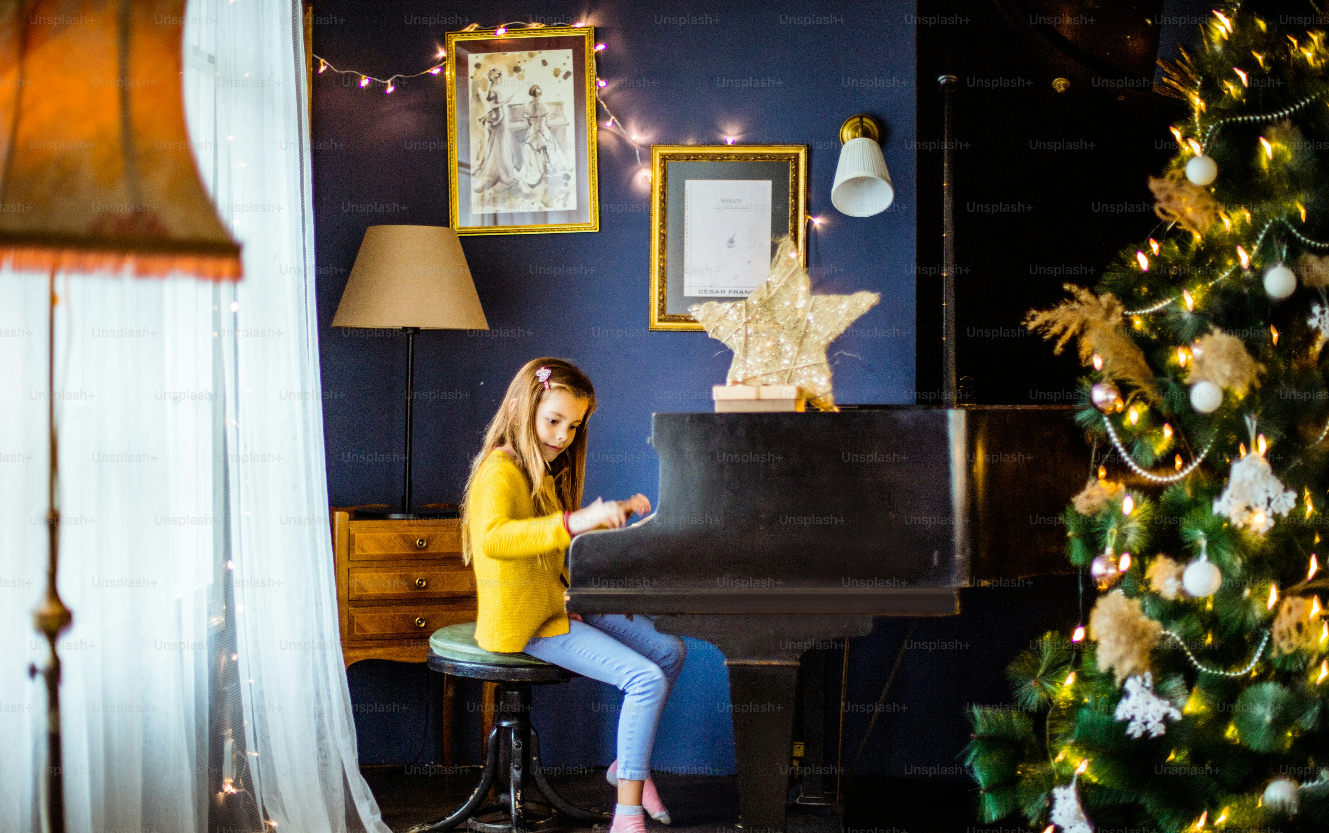 Focused on music. Little girl playing piano.