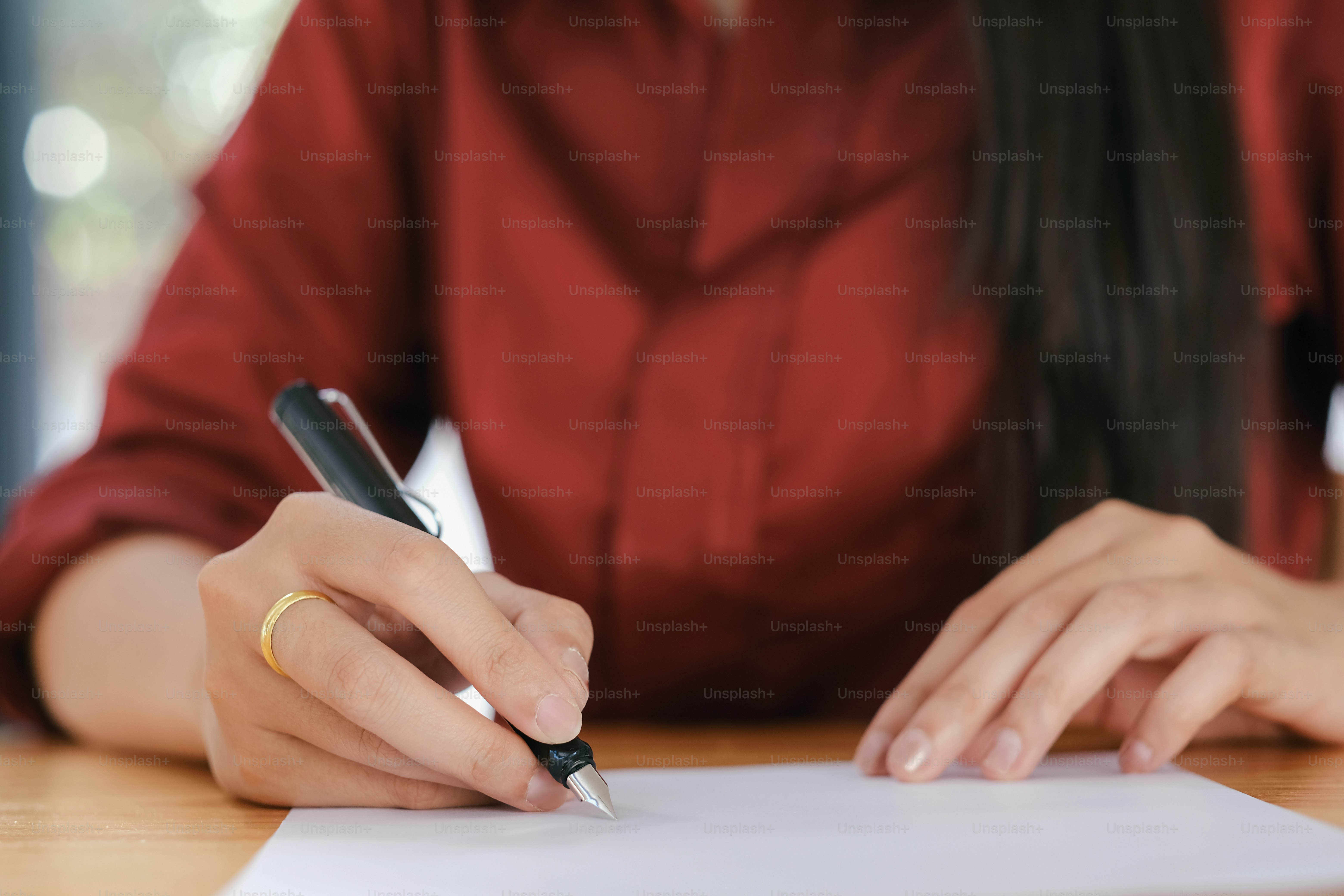 Asian Business woman signing a contract document making a deal.