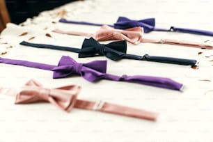 stylish bow ties on white background with space for text. groom and groomsmen getting ready in morning for wedding ceremony. classic official detail