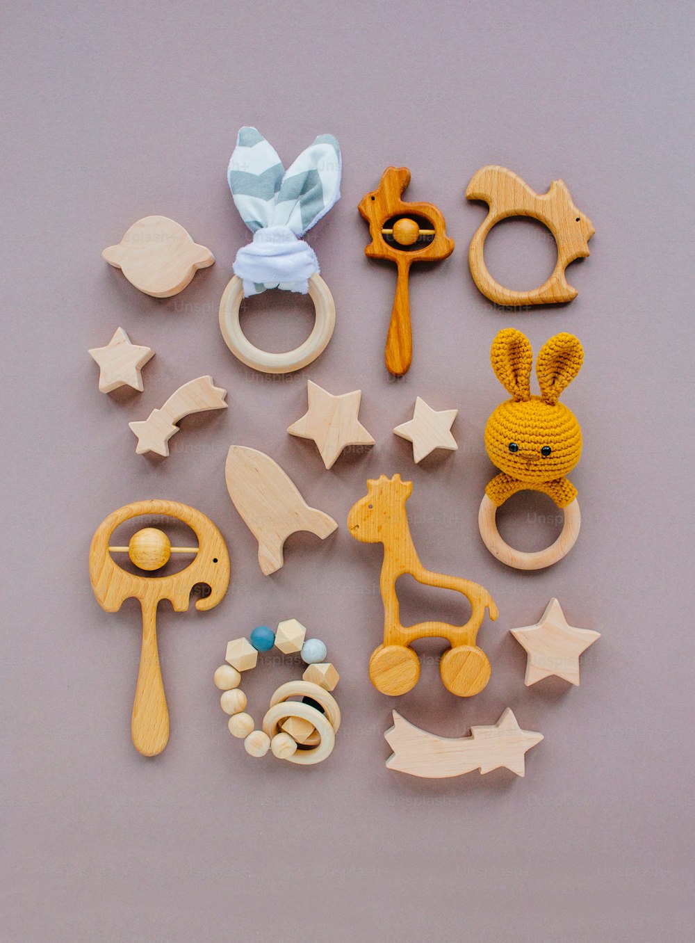 Eco friendly non plastic toys concept. Wooden toys and teethers on grey background with blank space for text.