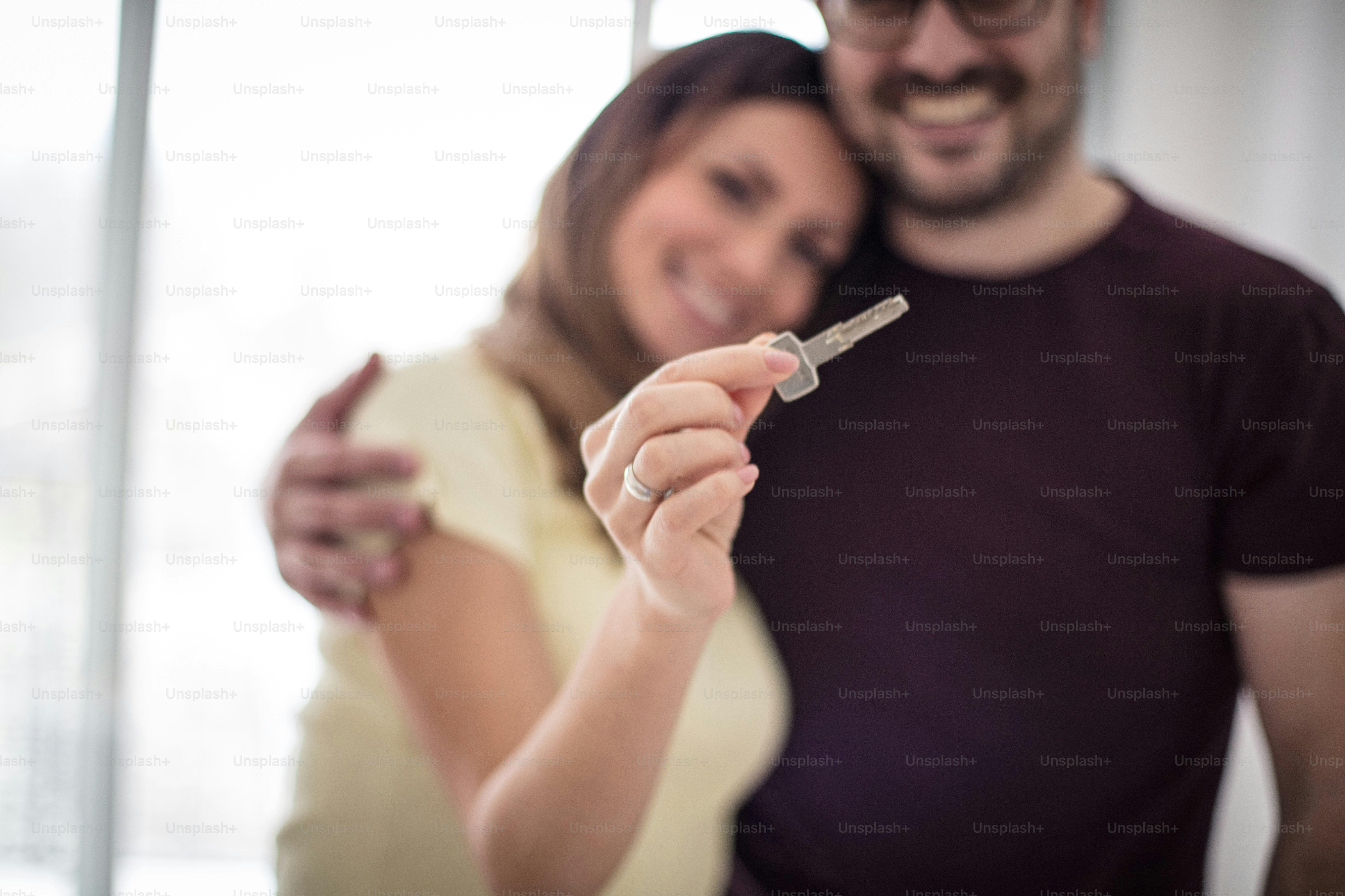 Our new life starts now. Couple in new home. Focus on hands. Close up ...