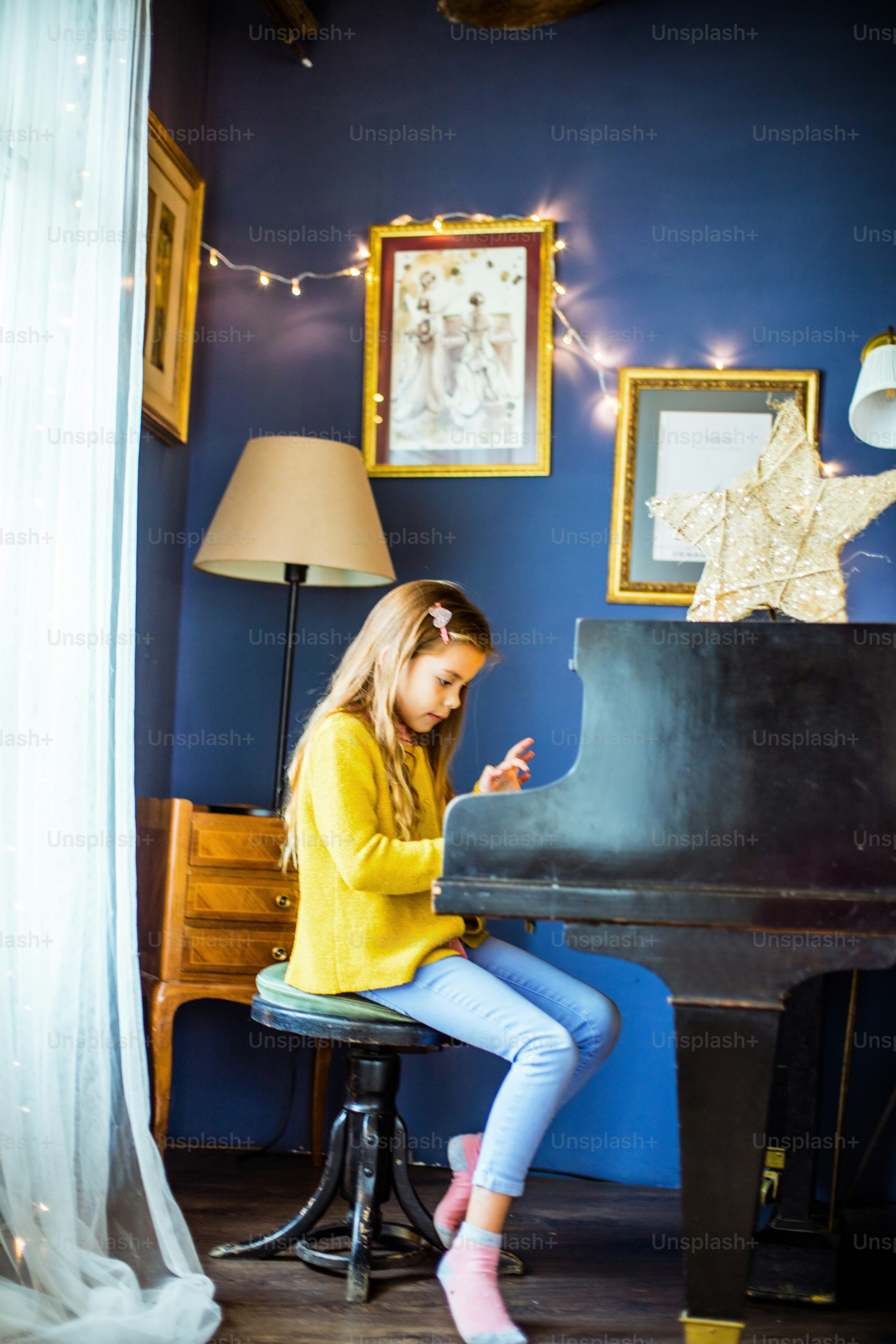 Music is her love. Little girl playing piano.