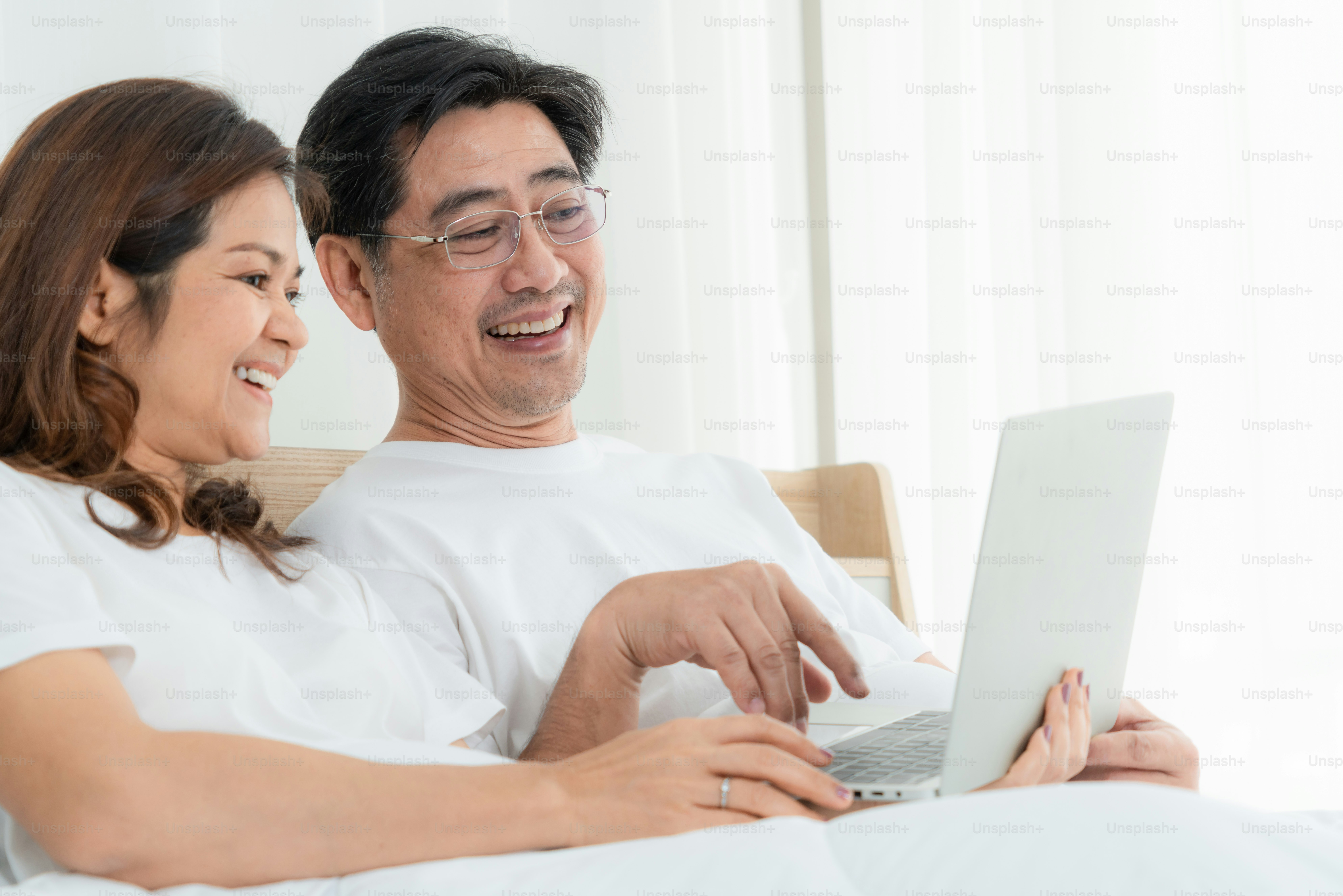 Happy Asian senior couple having good time at home. Old people retirement and healthy citizens elderly concept.