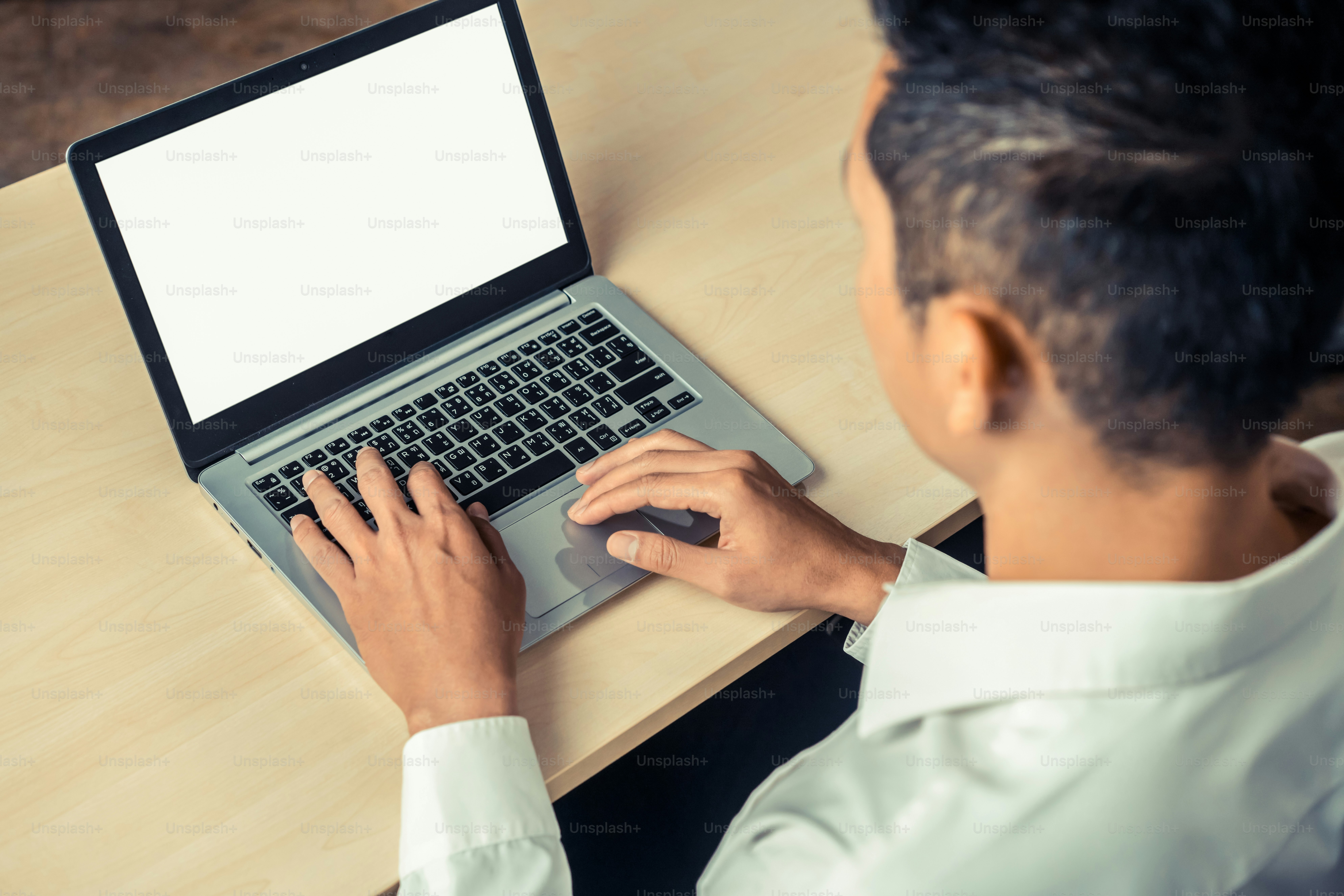 Business person or office worker using laptop computer while sitting at ...