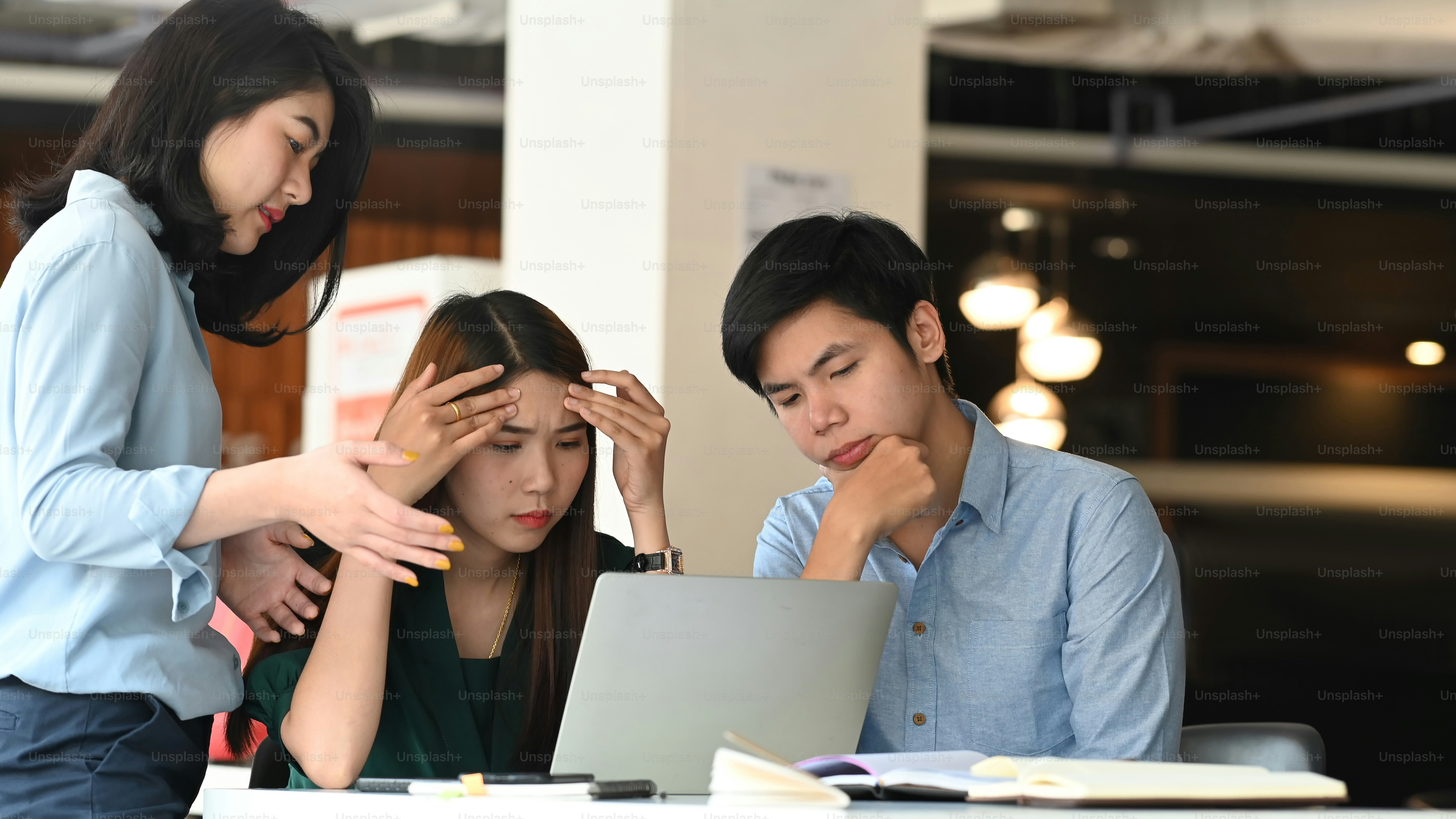 People looking at laptop in workspace - Photo on Unsplash+