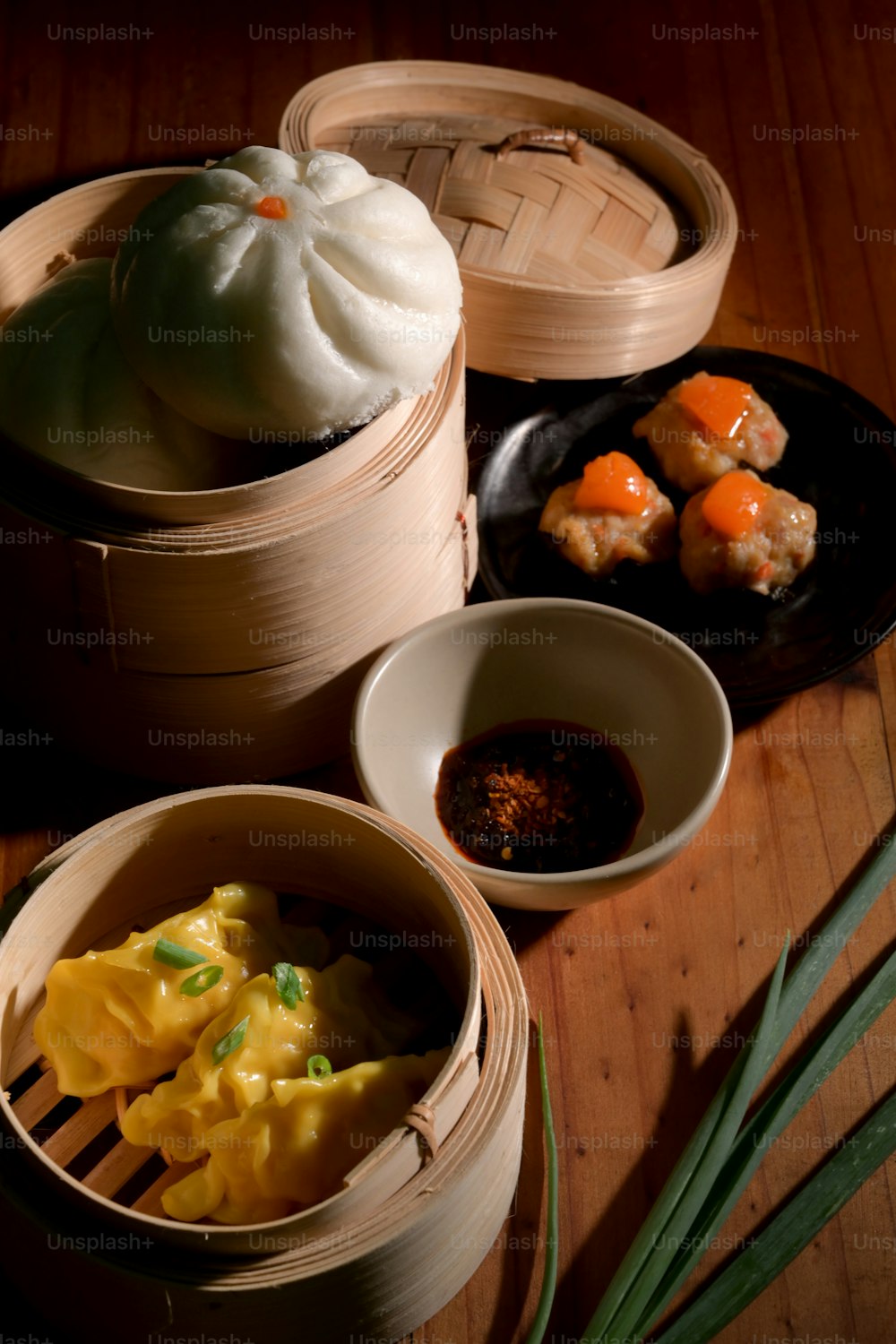 Cropped shot of Dim sum, Home made Chinese dumplings, steamed salted egg pork balls and bun served on traditional steamer