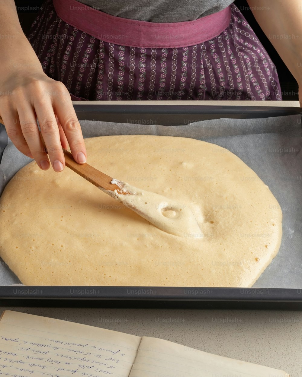 Preparation of a Swiss roll - spreading the raw dough over a baking sheet