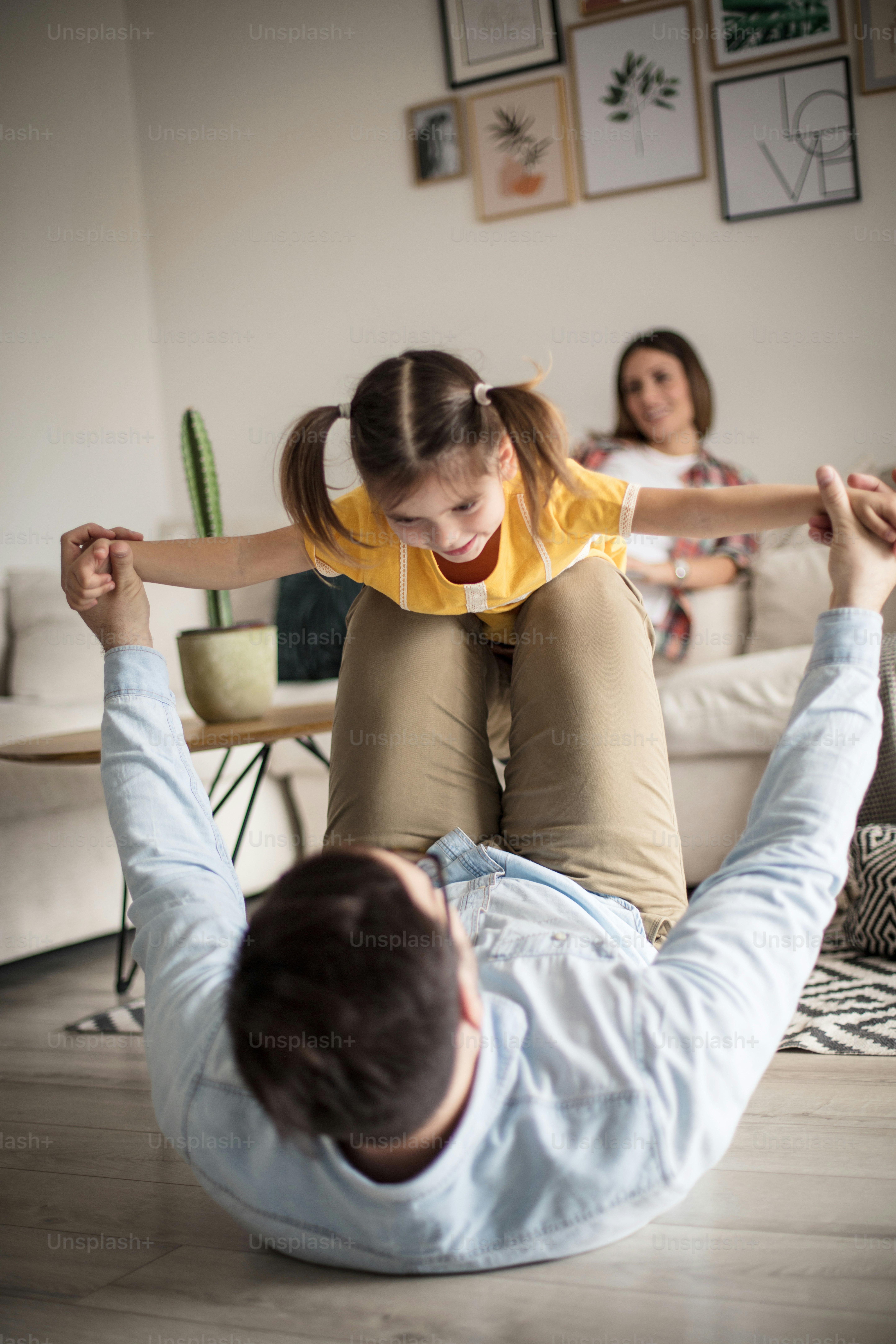 You are my little golden bird. Father playing with her daughter. Focus on foreground.