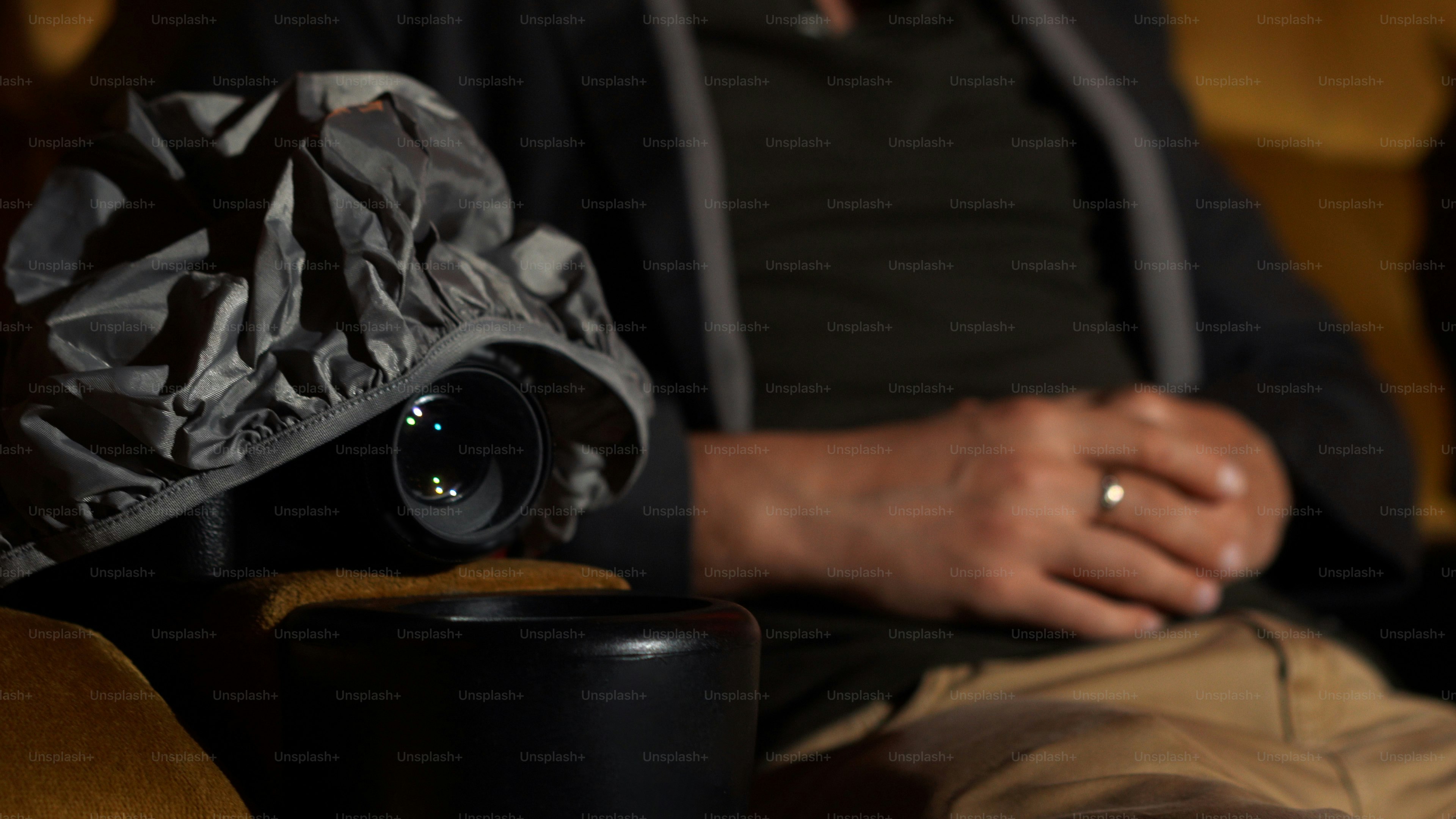 A man is secretly filming a video while watching a movie at the cinema