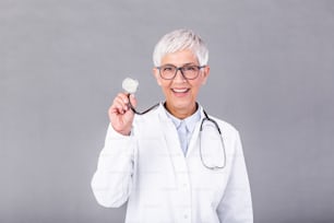 Female mature doctor with a stethoscope in the hands isolated on background. Doctor holds his stethoscope to insinuate that it's time for a check up in clinic banner