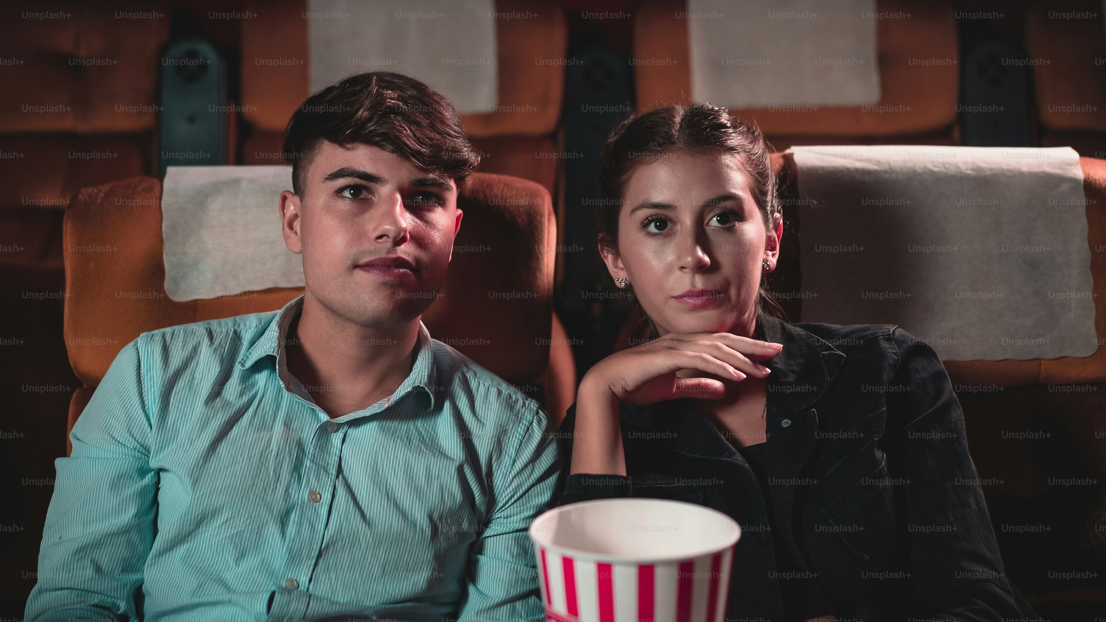 Men and women are watching mysterious movies and talking about the stories that happened in the movies.