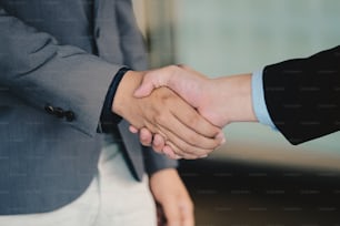 Close up of Business people shaking hands, finishing up meeting, business etiquette, congratulation, merger and acquisition concept