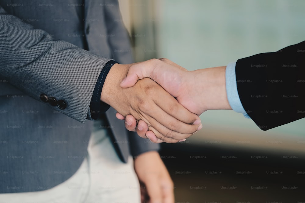 Close up of Business people shaking hands, finishing up meeting, business etiquette, congratulation, merger and acquisition concept