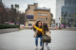 Our hugs are strong.  African American mother with her daughter at the city.