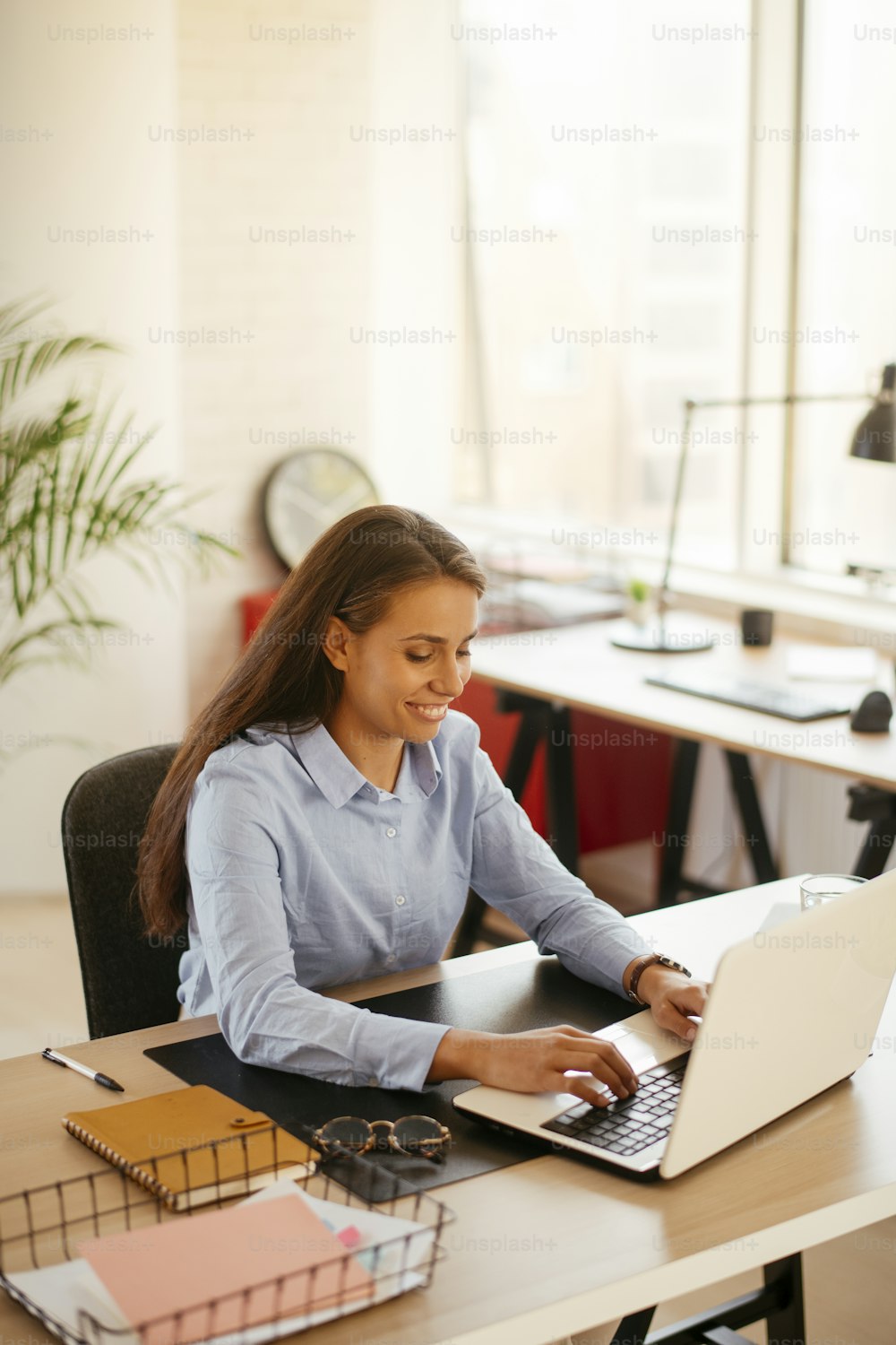 Businesswoman working. Beautiful young woman working in office.