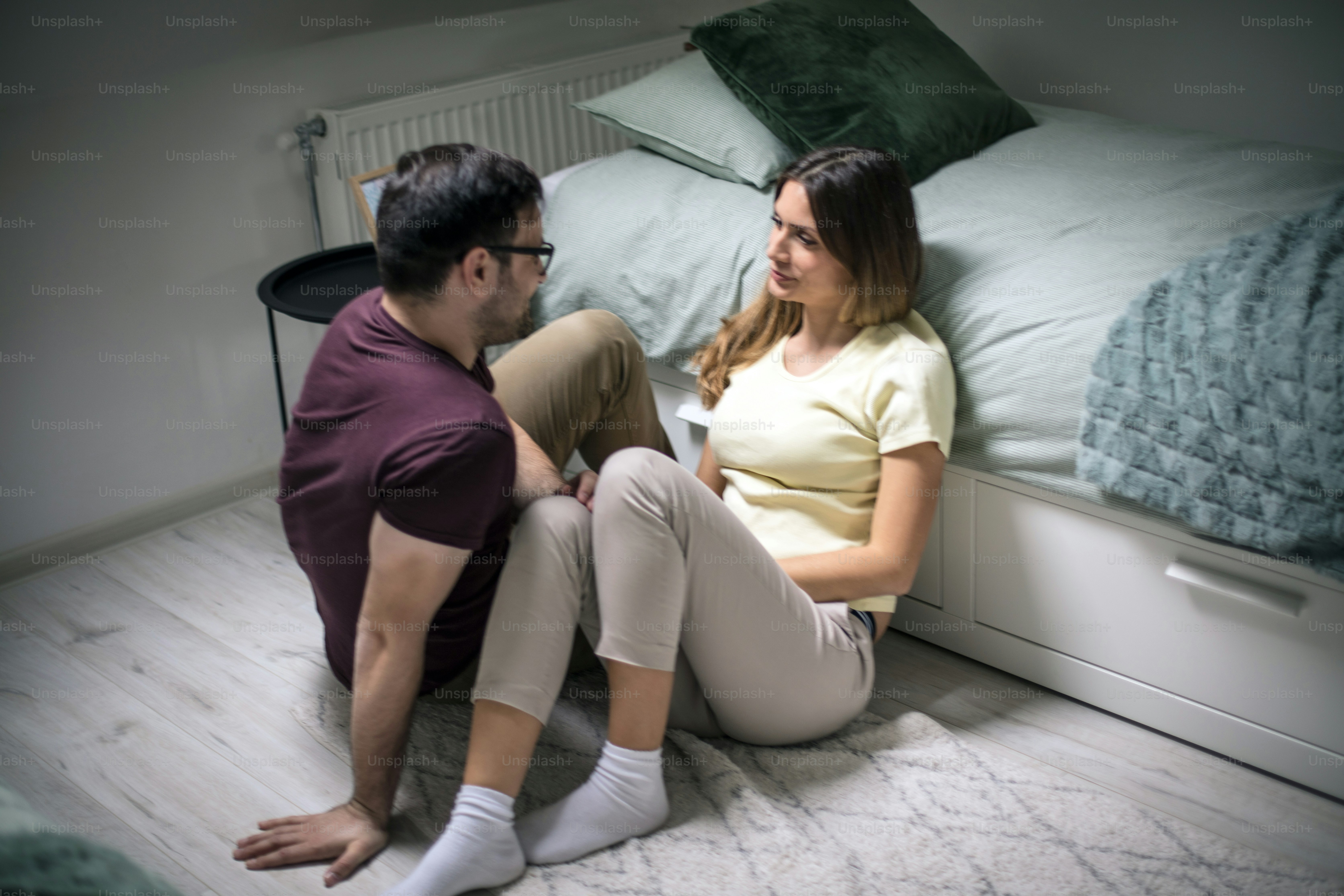 It is important that you always talk. Young couple in bedroom.