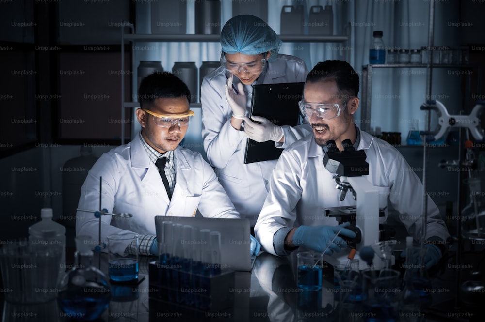 Team of Medical Research Scientists Collectively Working on a New Generation Experimental Drug Treatment. Laboratory Looks Busy, Bright and Modern.