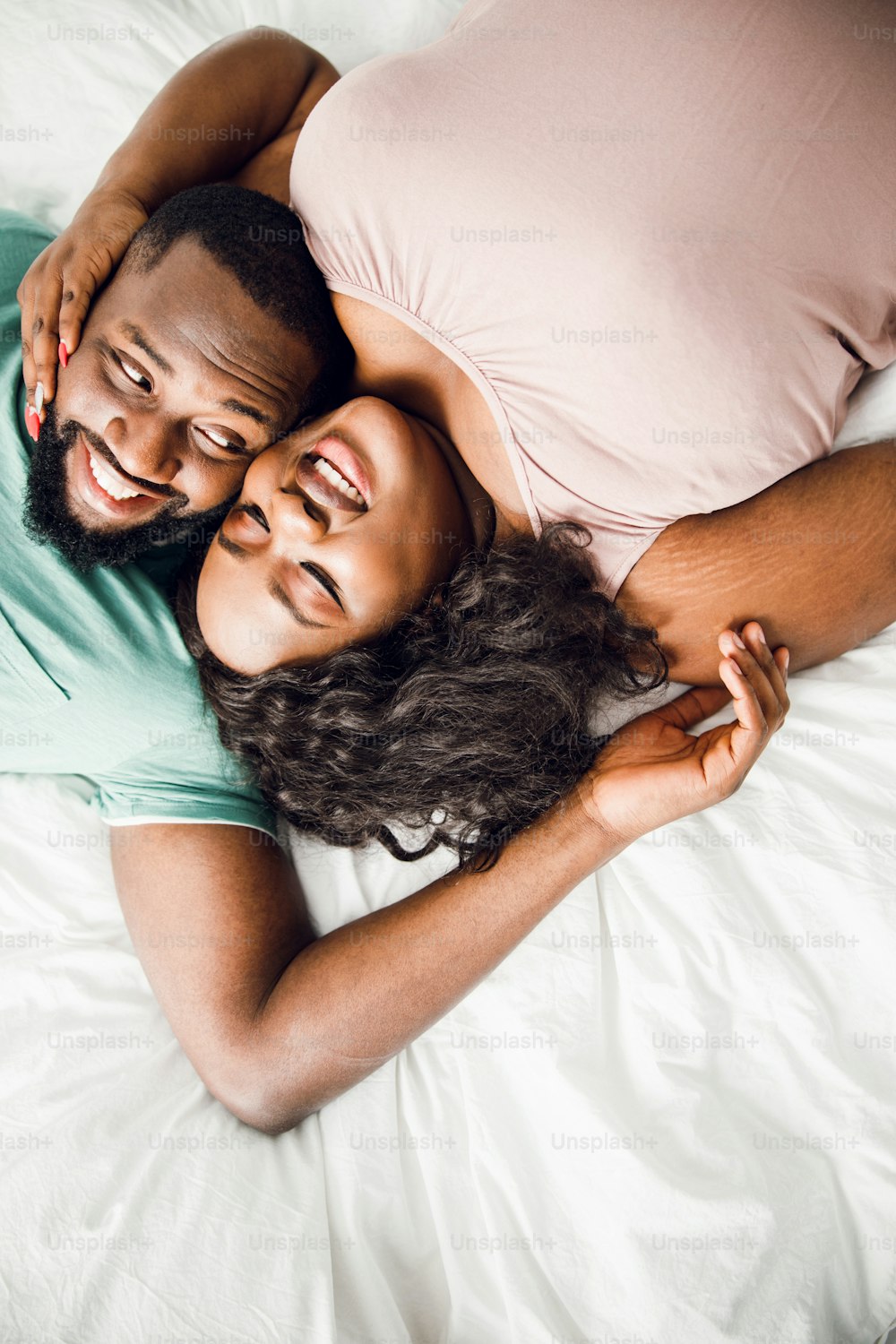 Top view of Afro American man and woman lying with heads towards each other