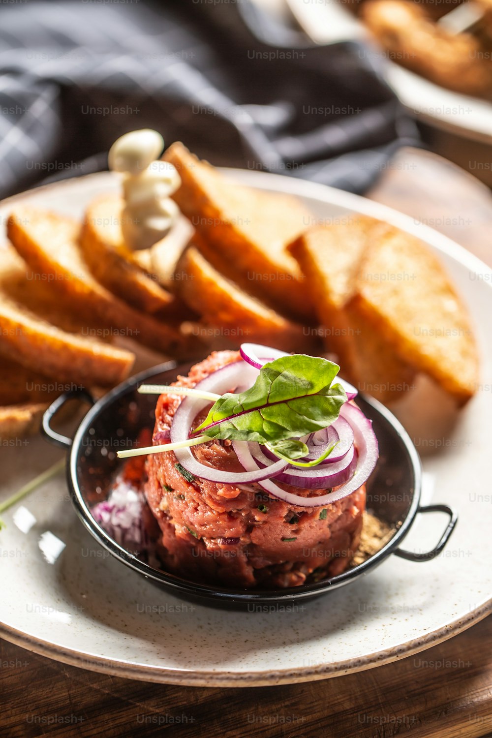 Beef tartare with red onion toast bread and garlic.