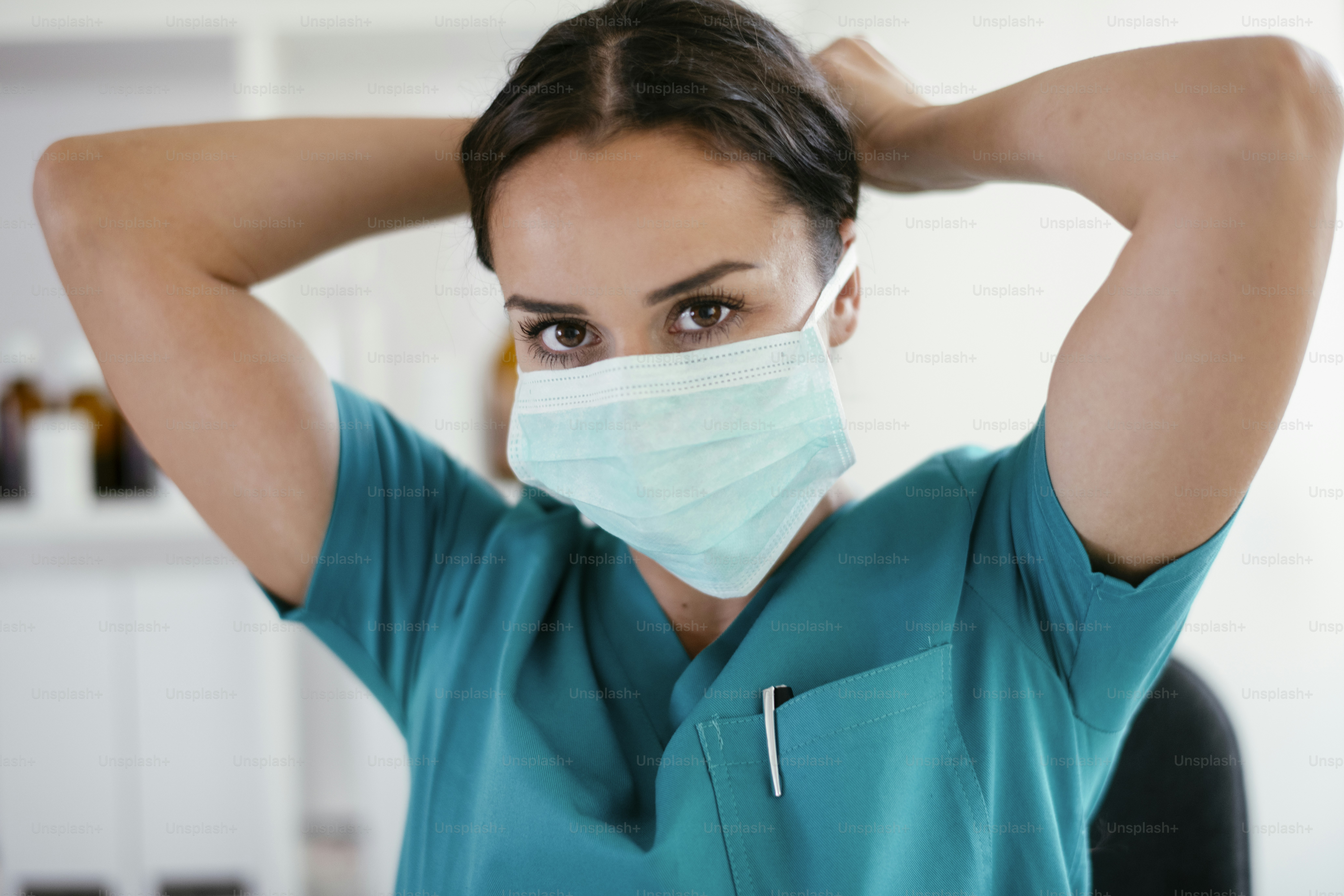 Young nurse with stethoscope. Nurse in green scrubs with stethoscope.