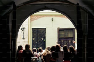 young happy women taking selfie at old european city street, stylish hipster girls, moments of happiness, friendship concept, view from back