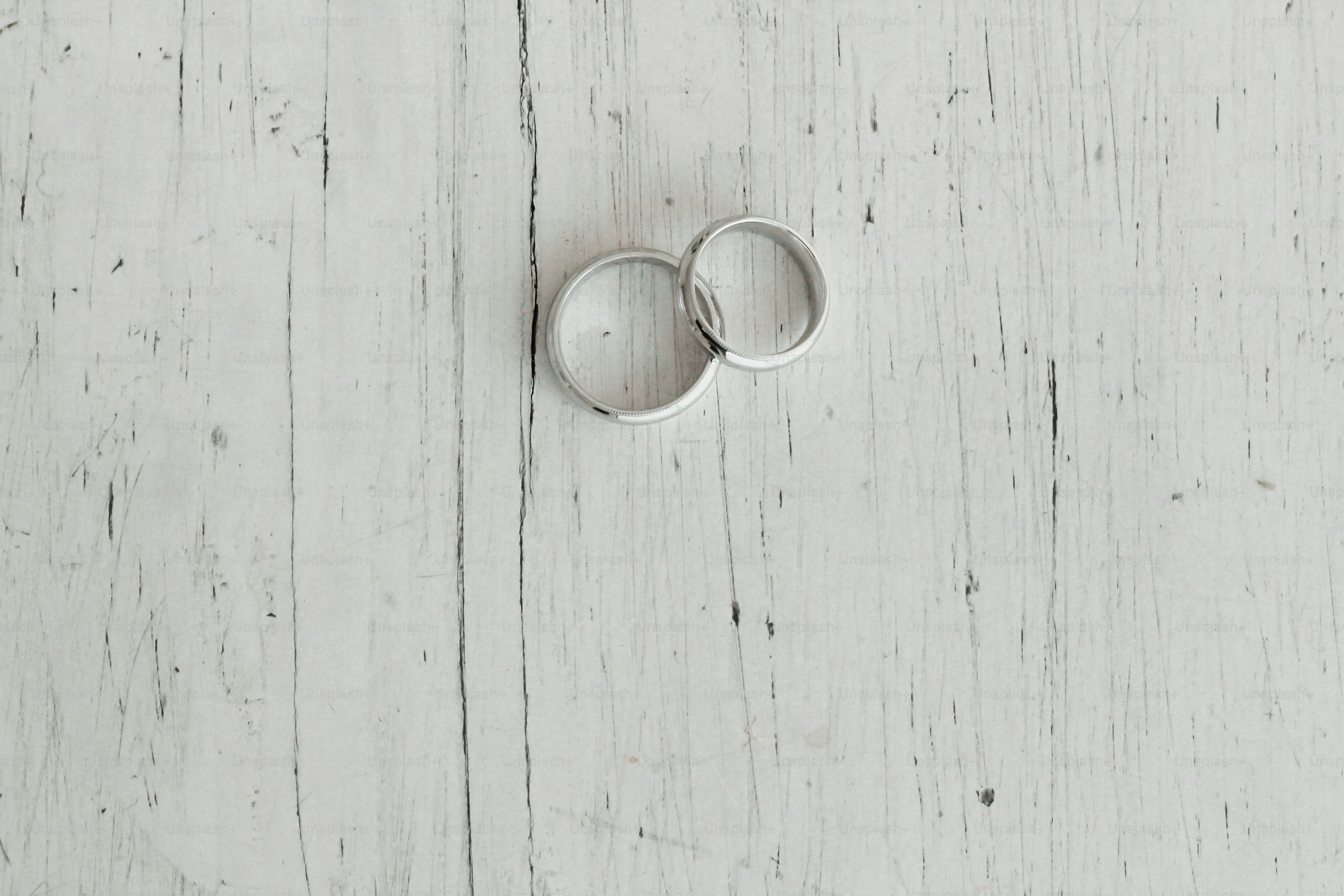 wedding rings on a wooden white background
