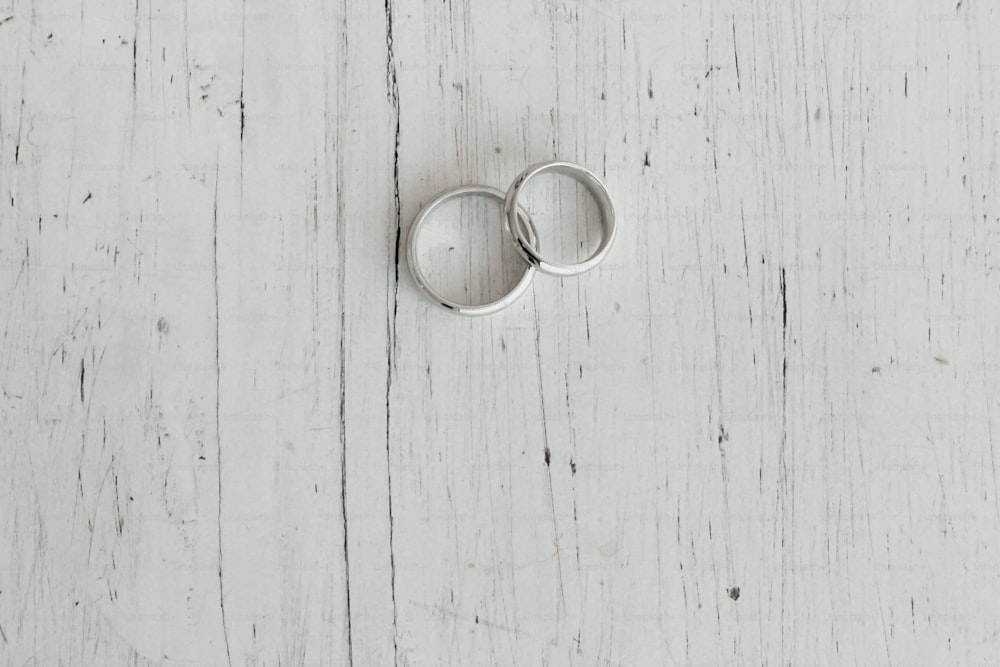 wedding rings on a wooden white background