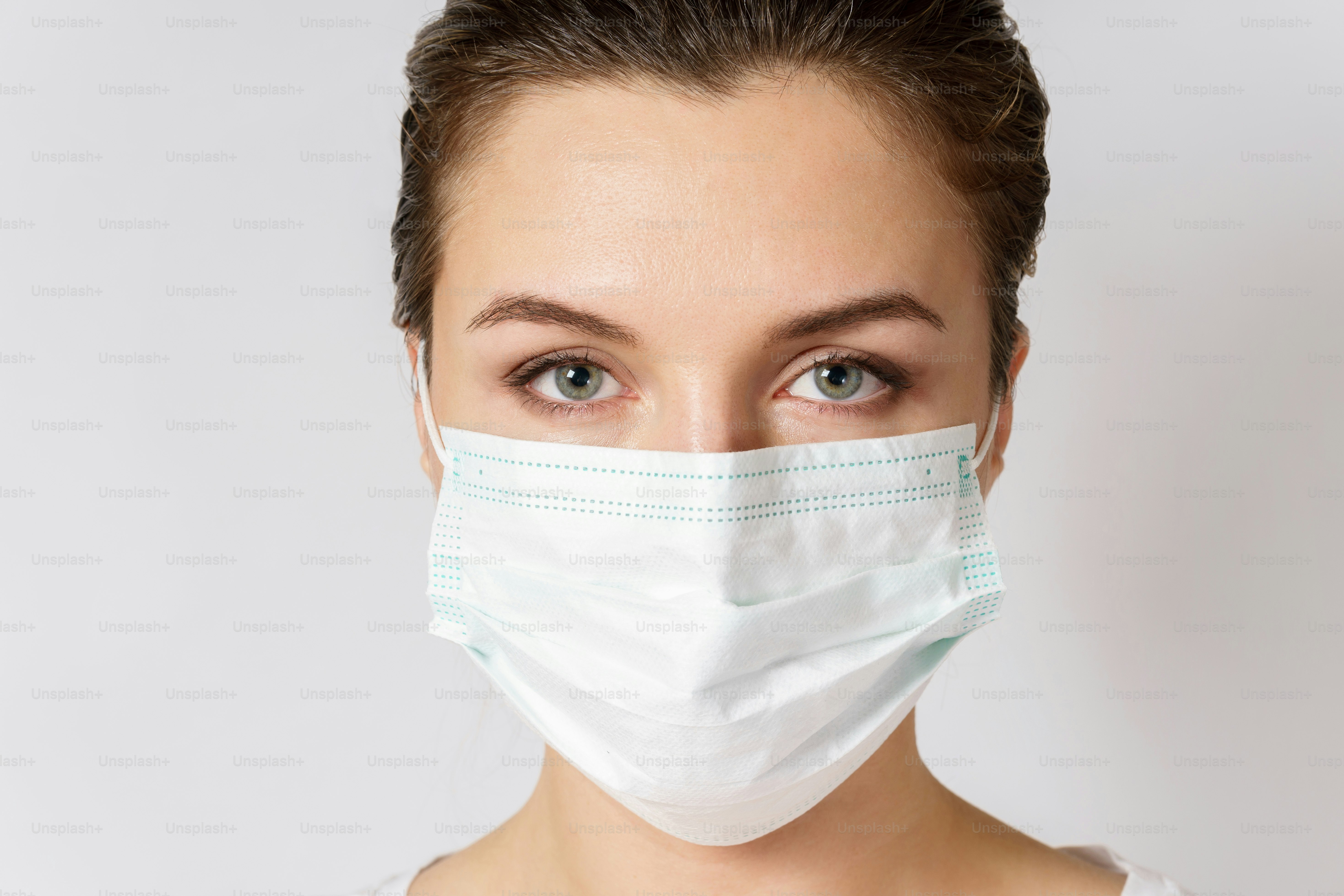 Young caucasian woman is wearing a face mask for protection against virus