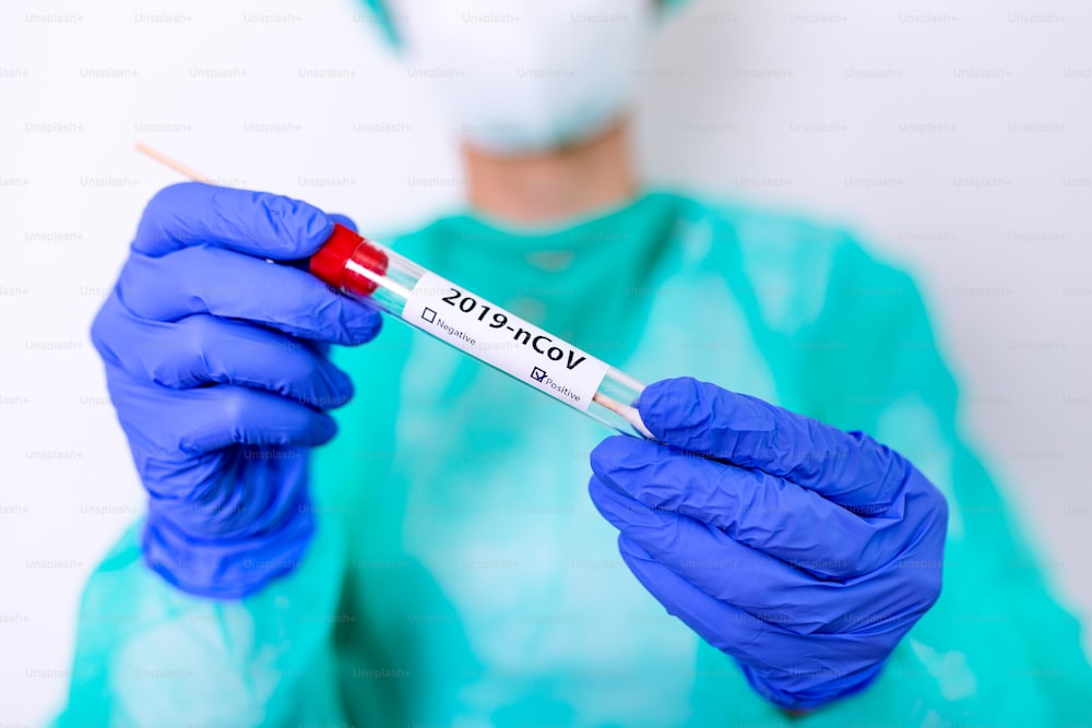 Coronavirus or COVID-19 concept. COVID-19 Diagnostic Test. Diagnostic testing for COVID-19. Nasal swab laboratory test in hospital lab. Specialist holding test tube with cotton swab.