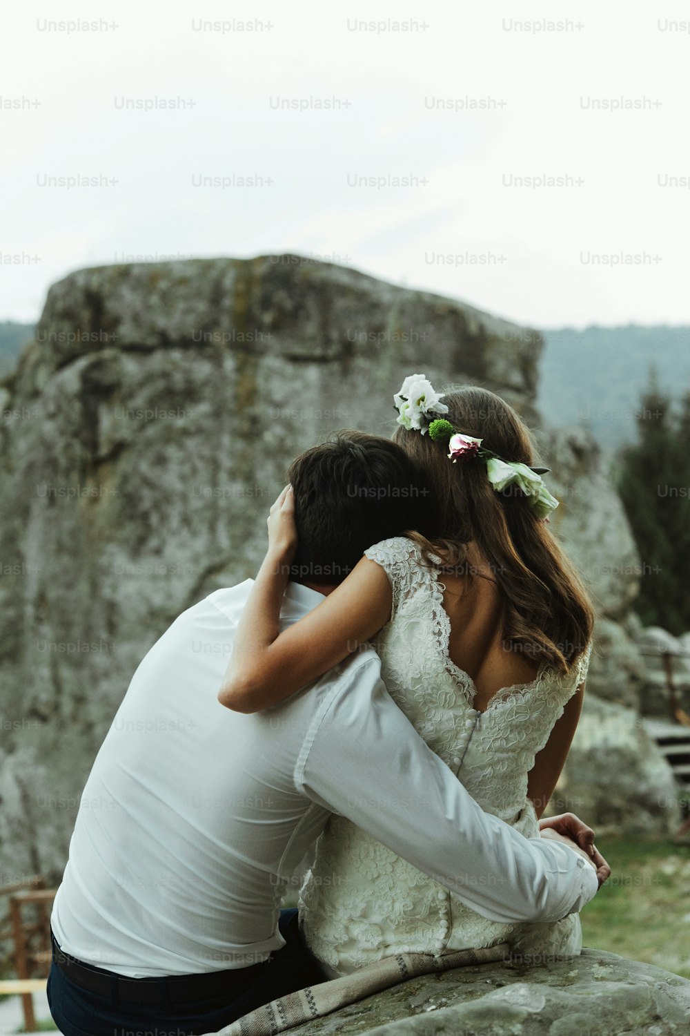 happy luxury couple of newlyweds hugging with tender on the top of a mountains in the evening