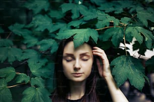 stylish woman under green leaf, posing modeling, atmospheric moody moment, save environment and eco concept