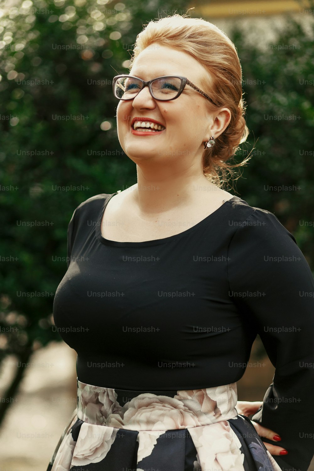happy stylish woman in glasses smiling at celebration in sunny park, luxury  life concept