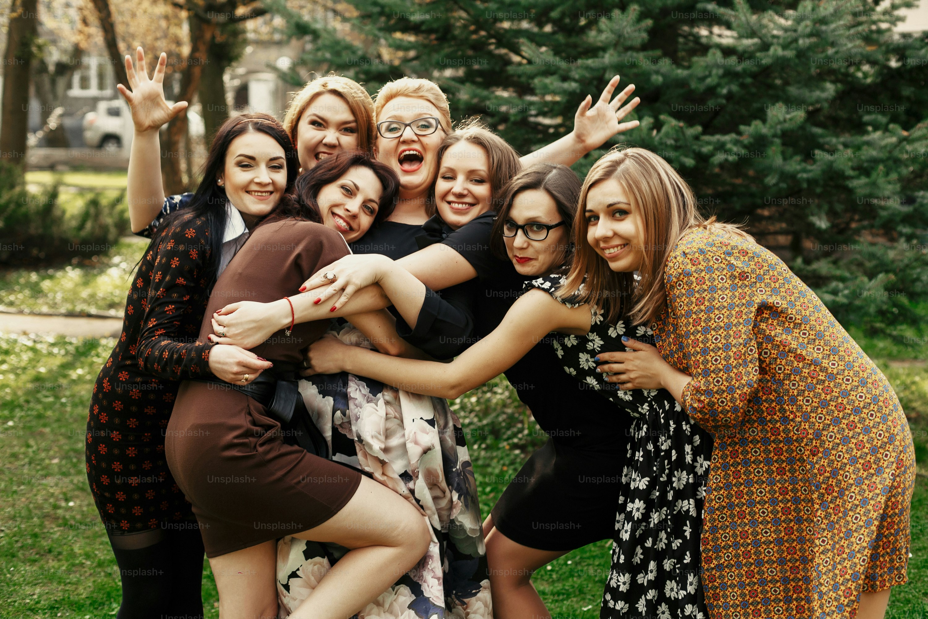 stylish elegant women having fun at celebration in sunny park, funny moment concept, gathering together