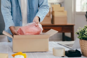 Online small business owner. Young startup entrepreneur online small business owner working at home, packaging and delivery situation.