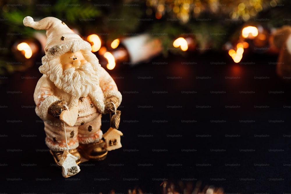 amazing beautiful green cedar and  christmas golden vintage garland lights and santa on black background