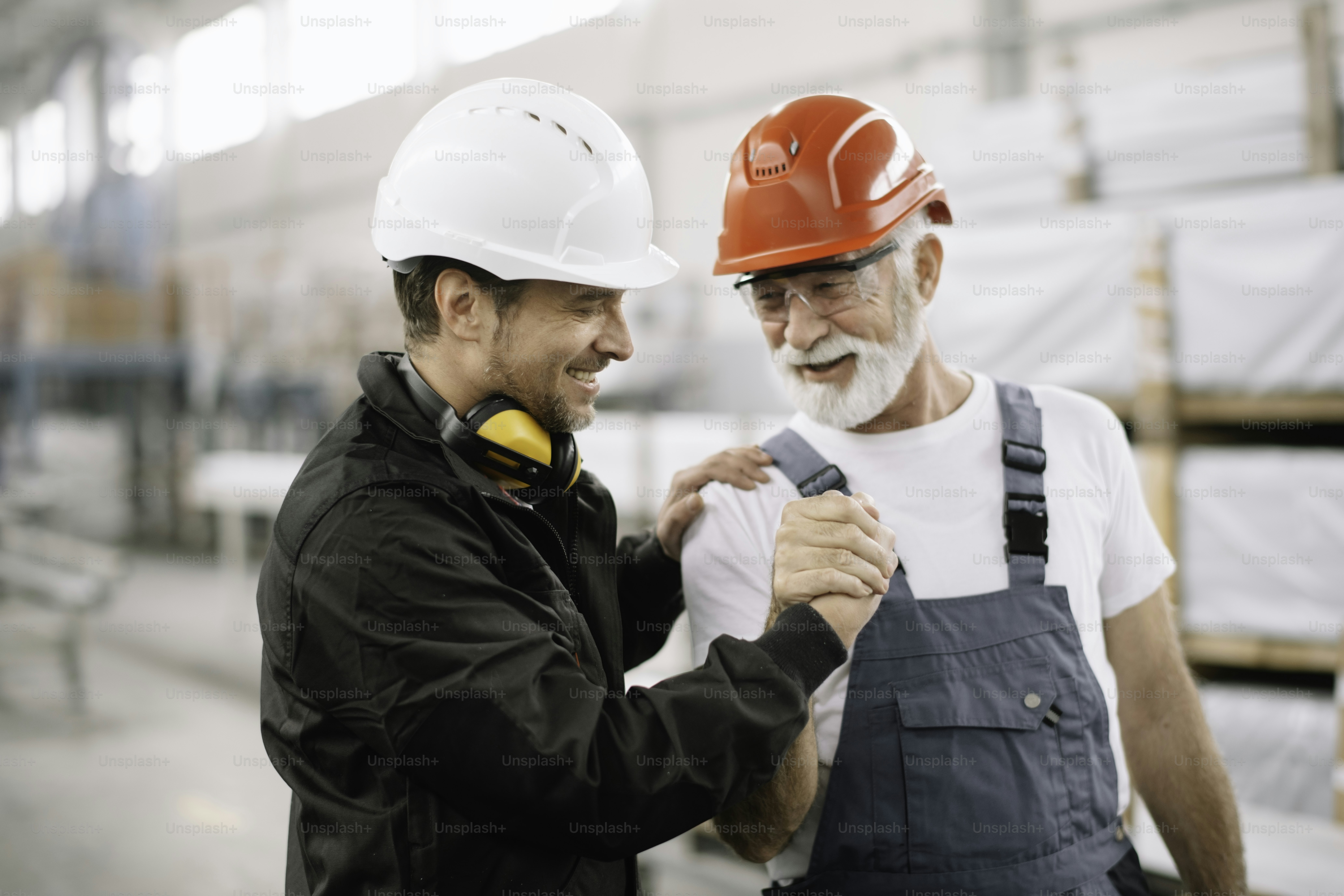 Colleagues working together in factory. Workers in factory.