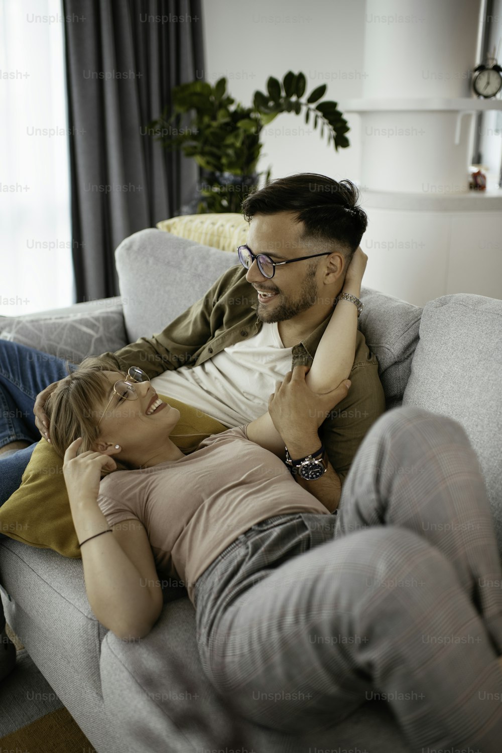 Young loving couple in sofa. Happy couple relaxing in living room..