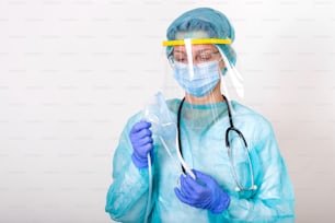 Arzt hält Sauerstoffmaske hoch, als wolle er Patient im Krankenhaus anlegen, Mitarbeiter des Gesundheitswesens in der Coronavirus-Covid19-Pandemie in Schutzausrüstung setzen Sauerstoffmaske auf Patientendiagnose des Coronavirus