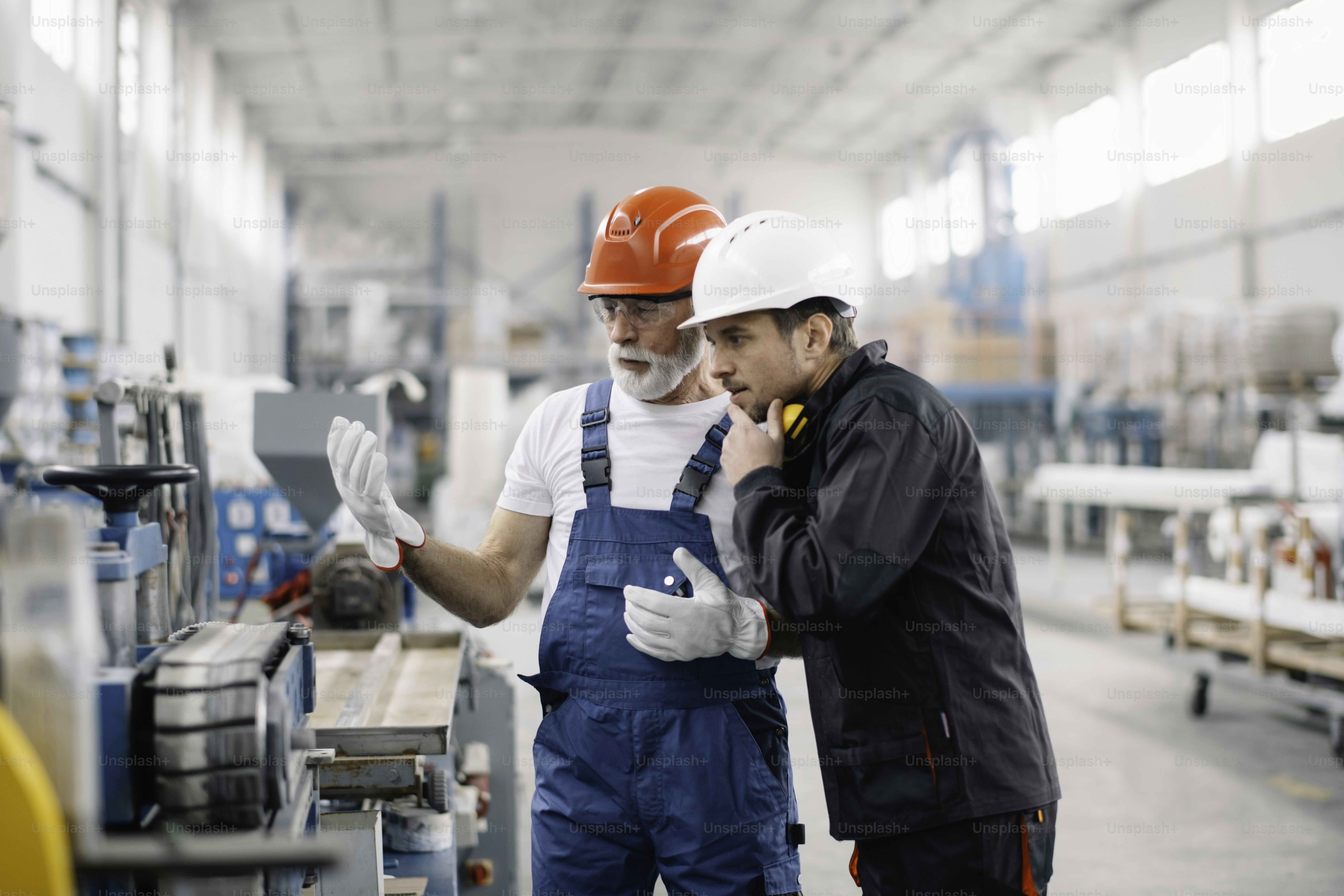 Colleagues working together. Workers in factory.