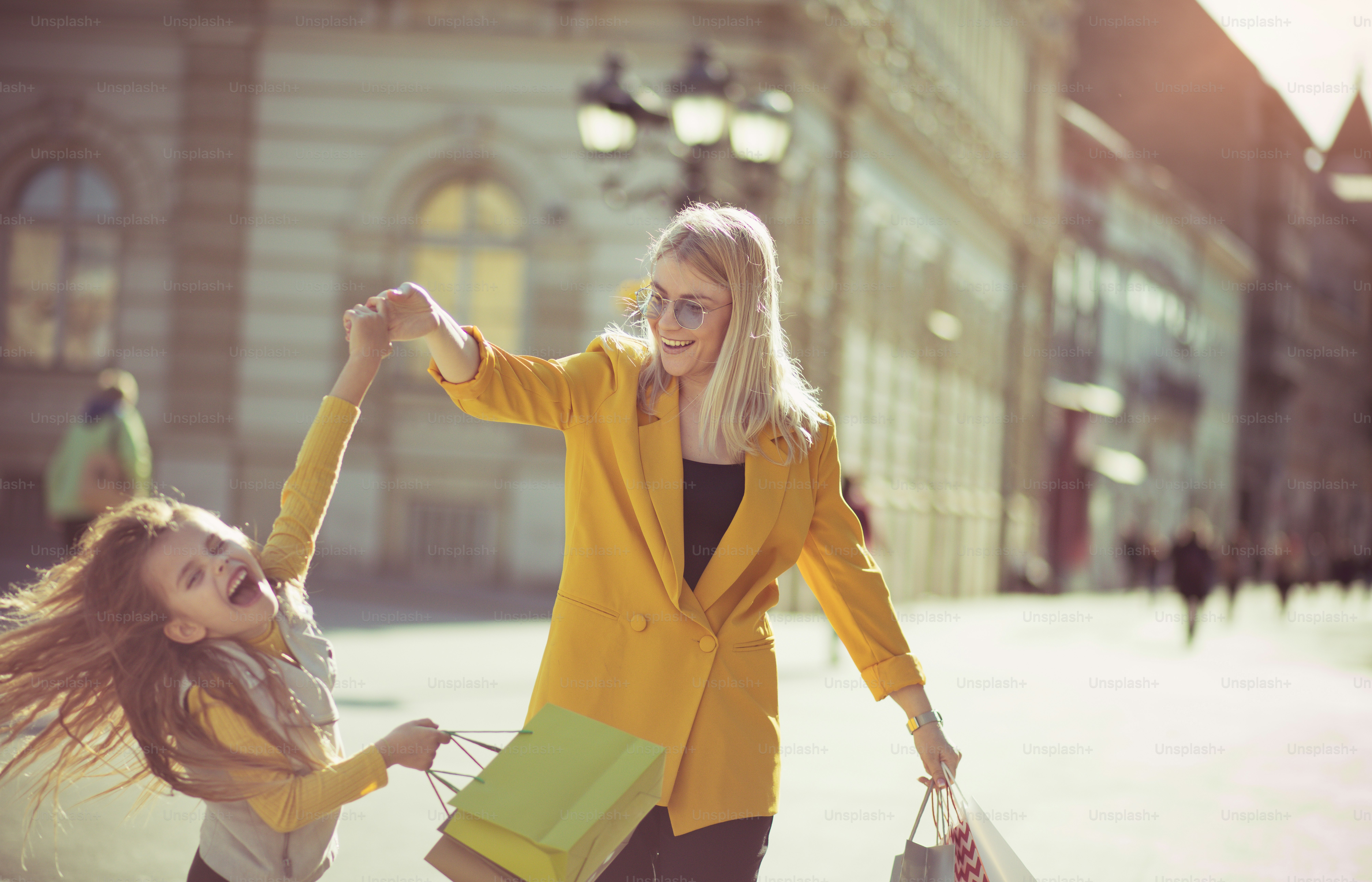 Fun only for girls. Mother and daughter shopping in the city.