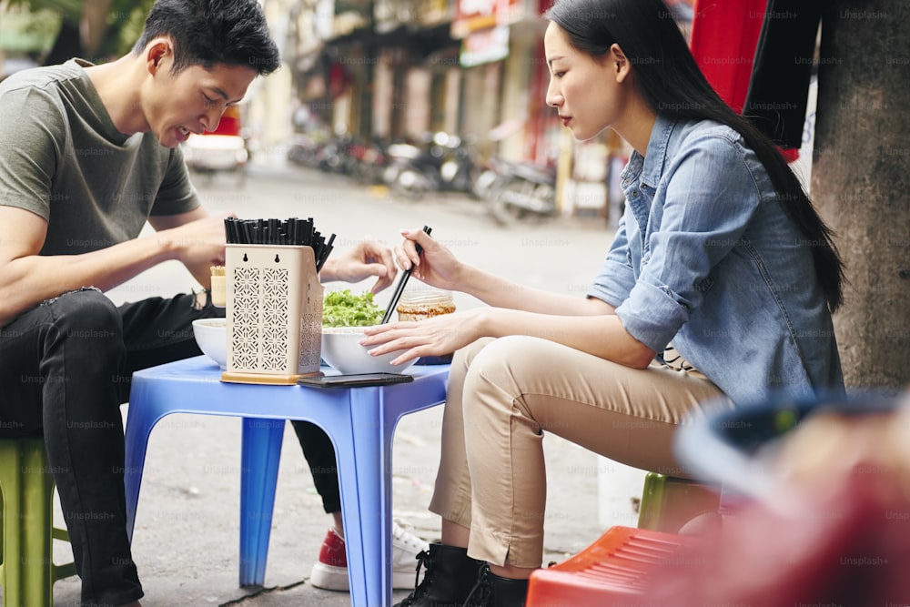 Turistas comiendo comida callejera en Vietnam