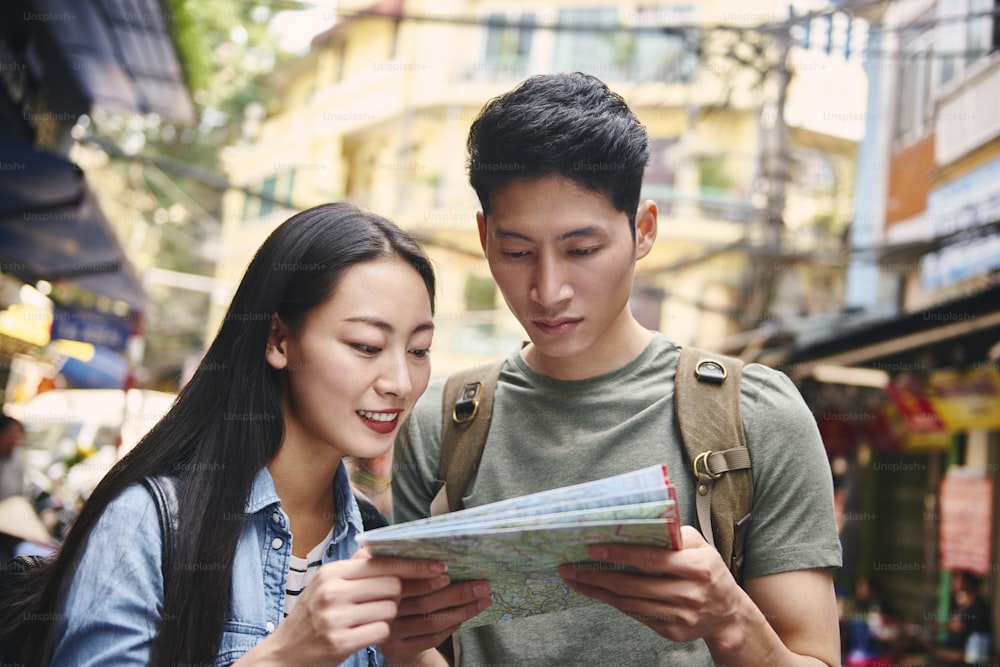 Tourists looking at paper map in the city