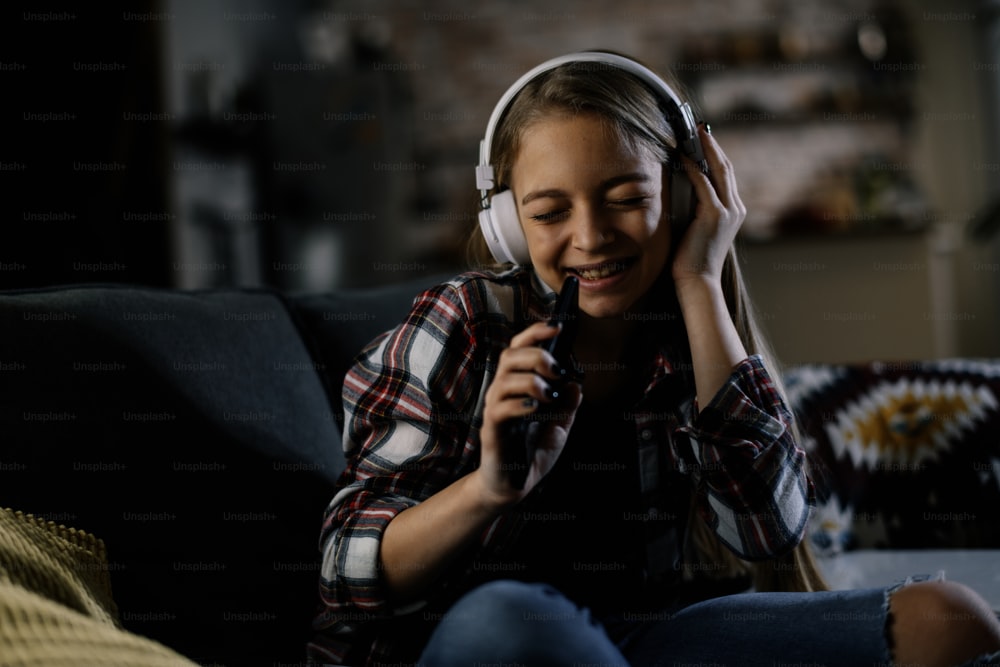 Beautiful young girl listening the music at home. Girl enjoying at home.