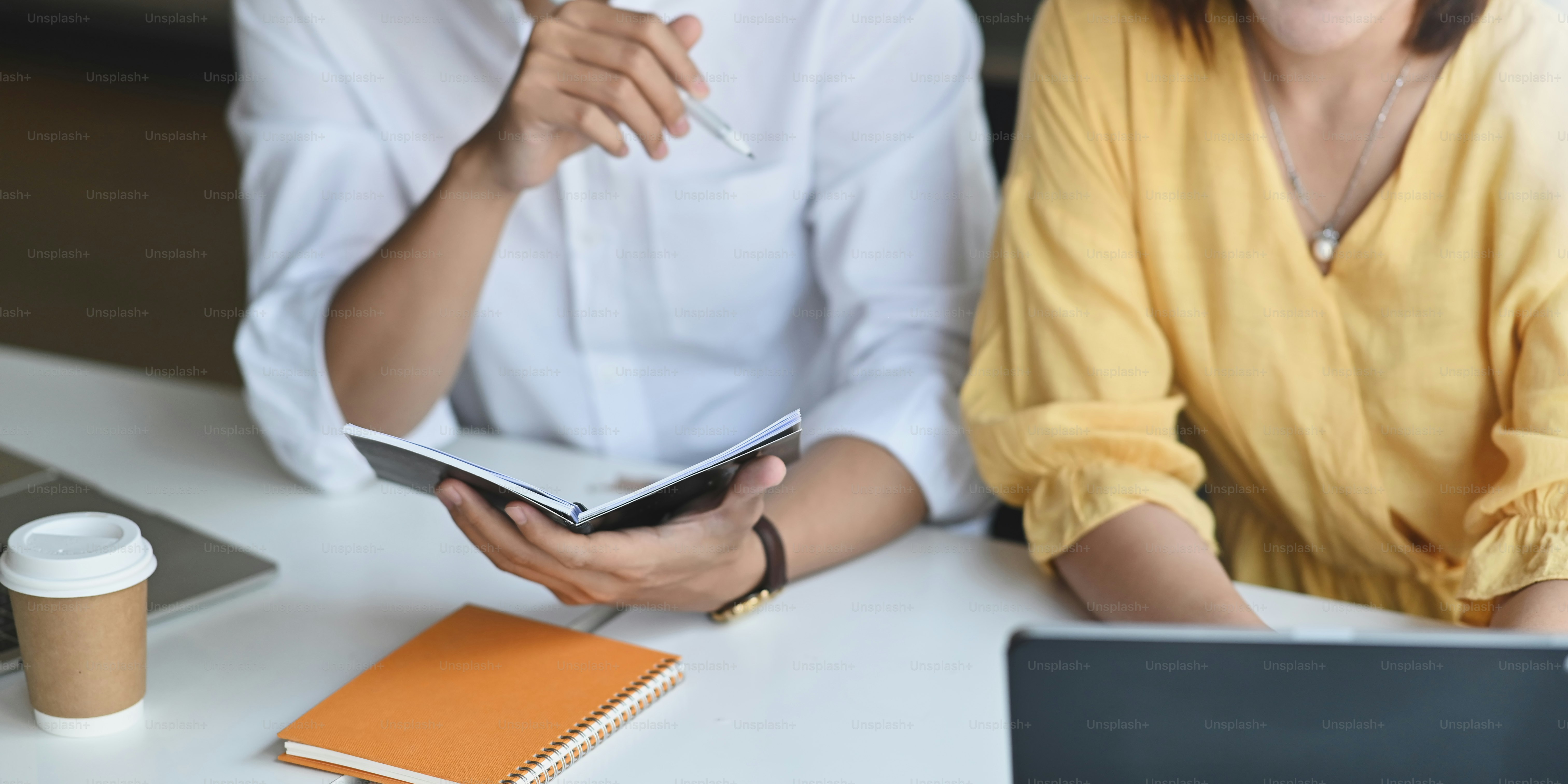 Cropped image of business people meeting with computer tablet and ...